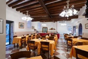 a dining room with tables and chairs and chandeliers at Hotel Tivoli in Venice