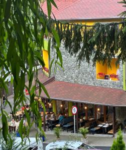 a restaurant with people sitting at tables in front of it at Pensiunea Izvoare Olanesti 3*** in Băile Olăneşti