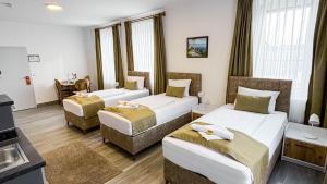 a hotel room with two beds and a kitchen at E&B Hotel in Korb