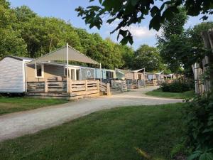 a row of cottages on a gravel road at Cozy Tiny SolHouse 7 - Near Groningen - 5 Star Location in Kropswolde