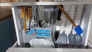 a drawer filled with utensils in a kitchen at Blue River in Minca