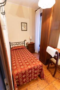 a bedroom with a bed and a table and a chair at Hotel Tivoli in Venice