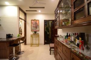 a kitchen with a counter and a bar with wine bottles at Pacation Home Stay in Noida