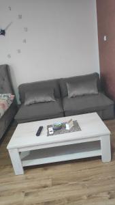 a white coffee table in a living room with a couch at Stan na dan Loznica in Loznica