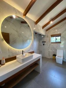a bathroom with a sink and a mirror at Cabaña Los Sauces en Buena Vista Santa Cruz in Buena Vista