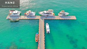 an aerial view of a dock with boats in the water at HANZ Lagoon Sunset Boutique Hotel in Phu Quoc