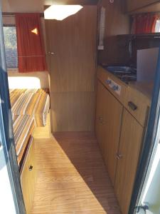 an interior view of a small kitchen in an rv at La Eriba Puck in Nort-sur-Erdre