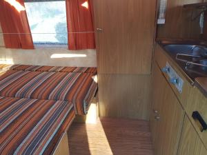 a small kitchen with wooden cabinets and a sink at La Eriba Puck in Nort-sur-Erdre