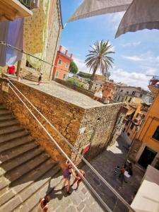 a group of people walking down some stairs with an umbrella at Arbanella in Corniglia