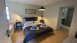 1 dormitorio con 1 cama grande y 2 toallas. en Villa Kalu in Central Istria for 6 people with private pool, en Mrgani