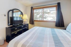 a bedroom with a bed and a tv and a window at East Bay 6 in Dillon