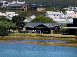 a view of a town with houses and a lake at A Rickety River House in Stilbaai
