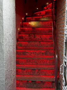 a set of red stairs with writing on them at Taksim Istiklal Suites in Istanbul