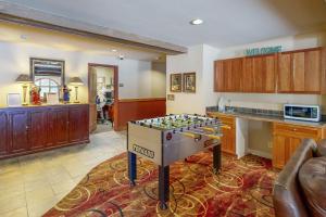 a kitchen with a table in the middle of a room at Red Hawk Lodge 2200 in Dillon