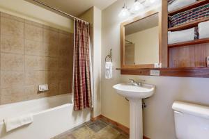 a bathroom with a sink and a toilet and a tub at Red Hawk Lodge 2200 in Dillon