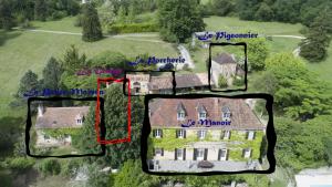 an aerial view of a large house with a red at Le Manoir De St Marcel in Saint-Marcel-du-Périgord