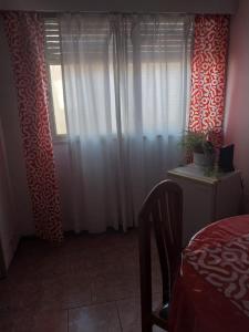 1 dormitorio con 1 cama y una ventana con cortinas en Apartment in the heart of the city en Mendoza