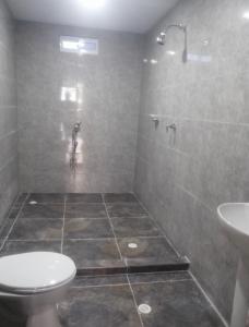 a bathroom with a shower and a toilet and a sink at House prado in Barranquilla