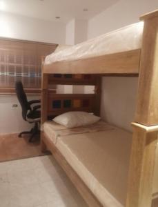 a bedroom with a bunk bed with a desk at House prado in Barranquilla