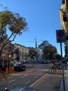 two people sitting at a table on a city street at La Piccola Mole - Turin Cozy Apartment in Turin