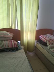Habitación con 2 camas y ventana con cortinas. en Departamento Marina Sol, Coquimbo, en Coquimbo