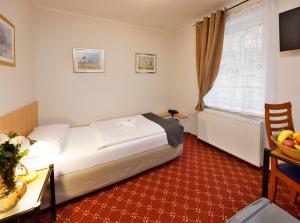 Ένα ή περισσότερα κρεβάτια σε δωμάτιο στο Hotel Boston