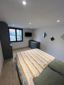 a bedroom with a large bed in a room at Le petit coin du Fau in Montauban