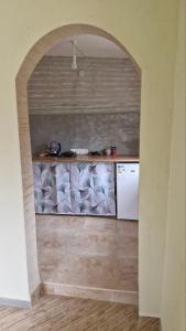 an archway in a kitchen with a white refrigerator at "Budur" Guest House in Agdan