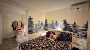 a bedroom with a christmas mural of trees on the wall at La stanza degli abeti blu in Rome