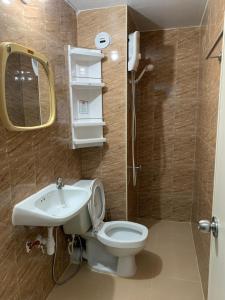 a bathroom with a toilet and a sink and a mirror at Muangthongthani Rental/Khun Dan in Nonthaburi +131 photos