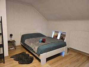 a bedroom with a bed with a hat on it at Le caillou Blanc in Charleroi