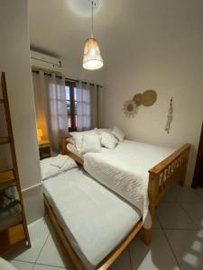 Ένα ή περισσότερα κρεβάτια σε δωμάτιο στο Quintal da Casa