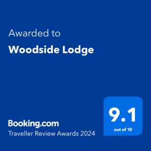 a blue text box with the words awarded to woodland lodge at Woodside Lodge in Thurstaston