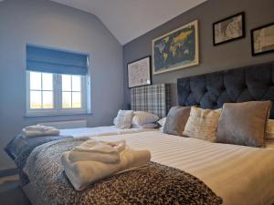 a bedroom with two beds with towels on the bed at The Star in West Leake