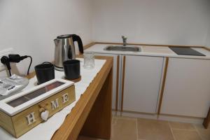 a kitchen with a sink and a counter top at Altemura Suites in Bari