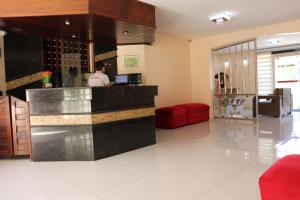 a man is standing at a counter in a lobby at MONTERREY HOTEL in Santa Inês