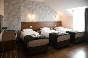 Postel nebo postele na pokoji v ubytování Hotel Garden