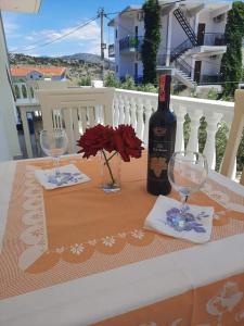 a bottle of wine and two glasses on a table at Villa Festim Ksamil in Ksamil