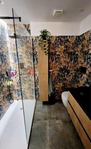 a bathroom with a toilet and floral wallpaper at La stanza degli abeti blu in Rome