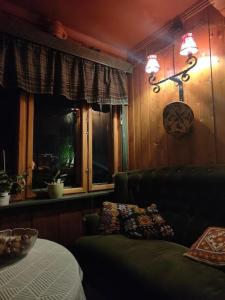 a living room with a couch and a window at Eikre Fjellgård in Hemsedal