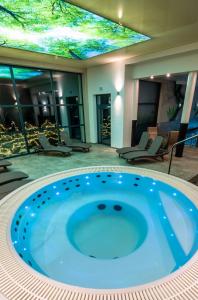 a jacuzzi tub in the middle of a building at Malina Apartamenty in Szklarska Poręba