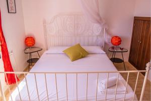 a bedroom with a white bed with two lamps at Casa Sirena VFT/AL/00853 in San José