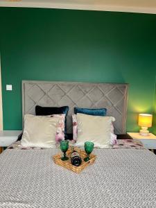 a bed with two green vases on top of it at Przytulna Apartment close to the airport and PKM in Gdańsk