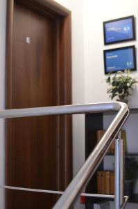 a staircase leading up to a brown door at Cozy apartment 2 rooms Prelungirea Ghencea in Bragadiru