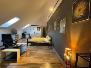 a bedroom with a bed and a living room with a couch at Savoya nr3 Studio Old City Center Self check-in in Timişoara