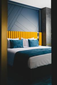 a bedroom with a large bed with an orange headboard at Stay inn Hotel Warszawa in Warsaw