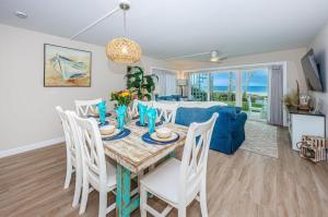comedor y sala de estar con mesa y sillas en Beachfront Aldea 13, en Clearwater Beach