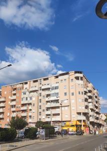 a large apartment building on the side of a street at Stan na dan Loznica in Loznica
