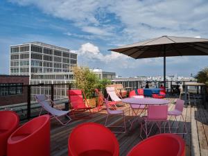 a patio with a table and chairs and an umbrella at URBAN LOFT Berlin in Berlin