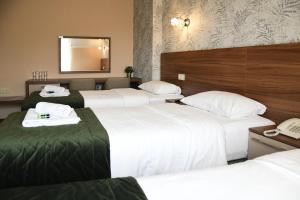 Postel nebo postele na pokoji v ubytování Hotel Garden